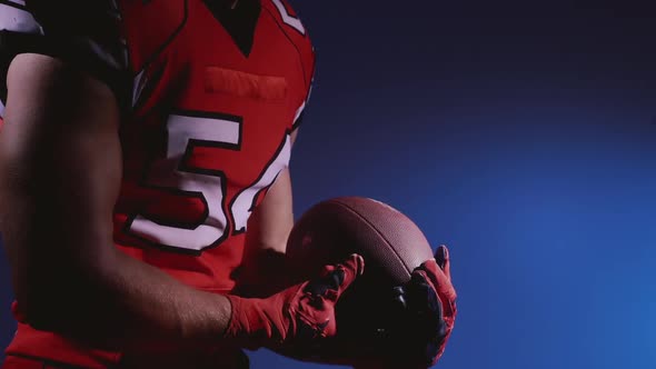 Faceless Determined Professional American Football Player in Helmet in Bright Stadium Illumination