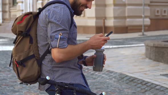 Cyclist Drinks Water on His Bicycle