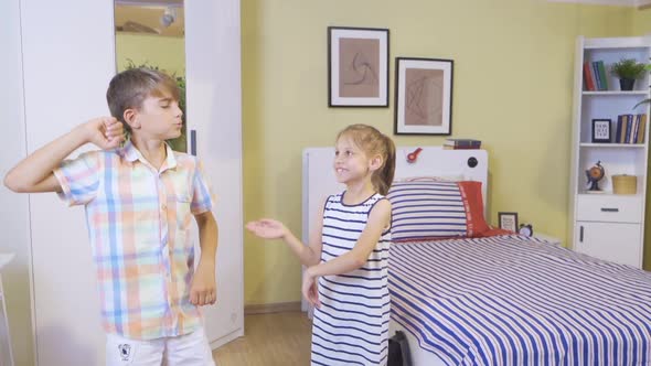 Two children are dancing in the room.