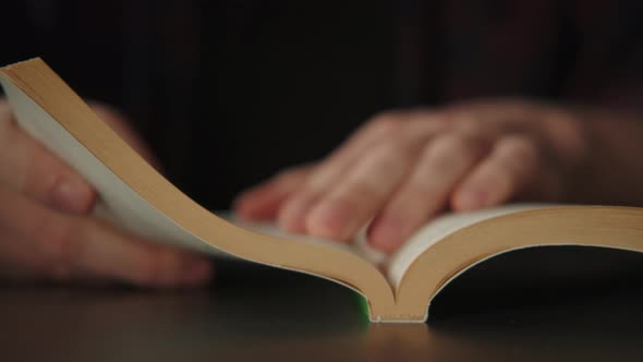 Paper Book on the Table a Man Reads Literature Turns a Page