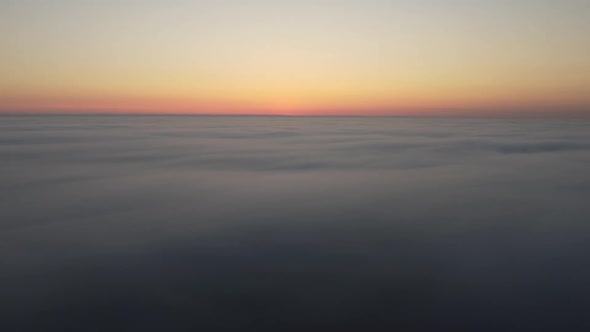 A Drone Watches the Sunrise Over the Fog