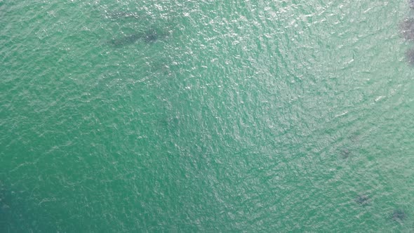 Aerial view of clear Atlantic ocean Llandudno coastline, Cape Town, South Africa.