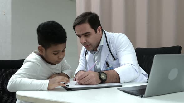 A doctor at an international hospital Trying to check up of a mischievous child in the hospital's OP