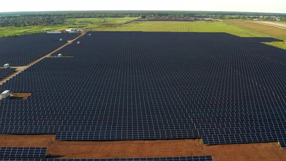 Top view of the power plant with solar panels. Beautiful green fields.