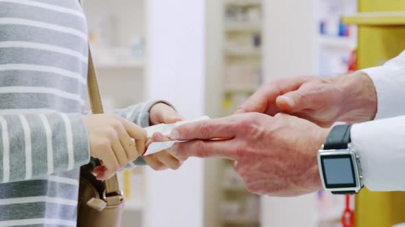 Pharmacist explaining prescriptions to customer