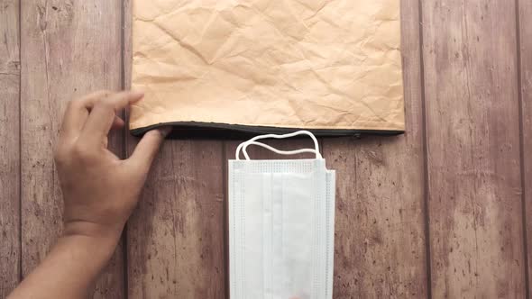 Close Up of Putting Blue Surgical Masks in a Small Bag