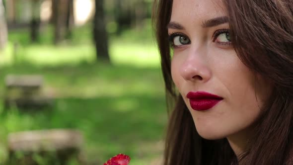 Pretty Woman Seductively Eating Strawberries