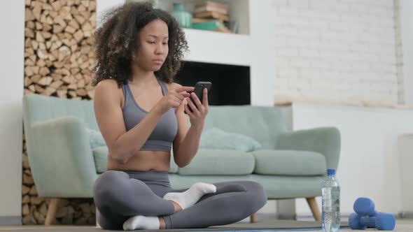 Fitness Young African Woman Using Smartphone