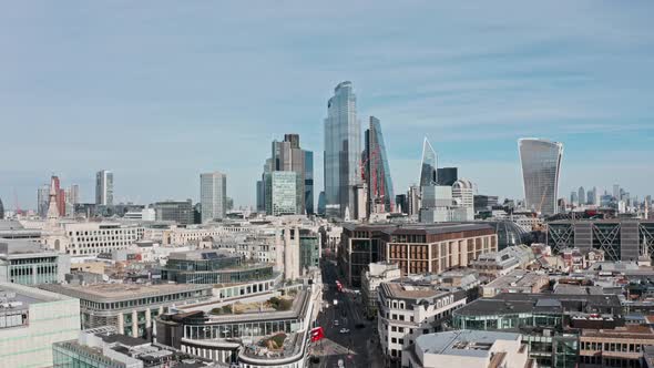 Slow drone shot towards Bank and city of London skyscrapers over queen Victoria street mansion house