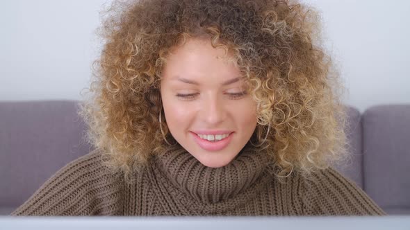 Beautiful young adult woman doing freelance work online with notebook computer in 4k video