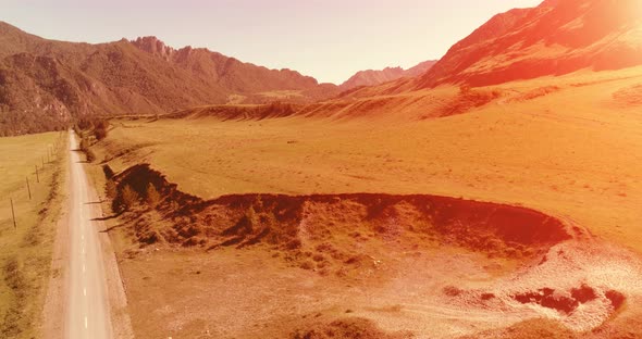 Aerial Rural Mountain Road and Meadow at Sunny Summer Morning