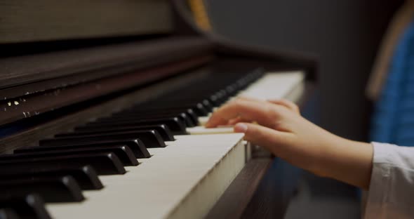 Little Girl Playing Piano at Home. Kid Play Piano in Living Room. Child Learning Piano at Home