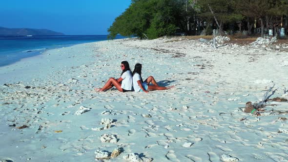 Beautiful women look beautiful on exotic seashore beach break by blue green sea and white sandy back