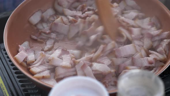 Sauteing Pork Meat In Tiny Cuts In A Pan. close up