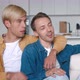 Happy Men Homosexual Couple Sit at Home Together on Their Sofa in an Embrace - VideoHive Item for Sale