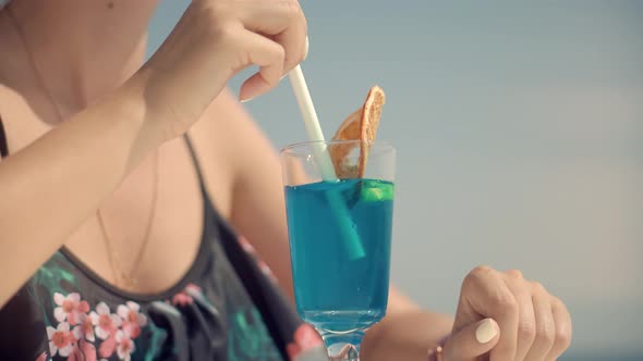 Woman Drinking Alcohol Blue Curacao Cocktail In Bar. Summer Holiday Vacation Travel On Sea.