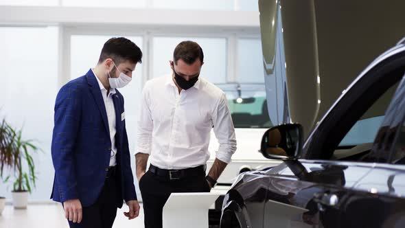 A Salesman Tells Specifications of a New Car Model to a Client