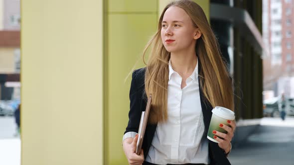 Confident Young Woman in Suite and White Shirt Walking in City Near Office