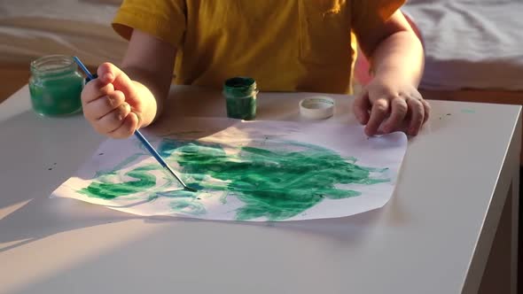 Little Boy Draws Picture On Paper