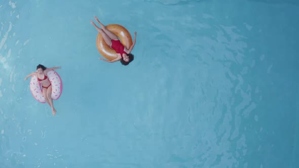 Distant Shot of Two Beauty Brunette in Red Swimwear Relaxing at Home or Hotel Pool, Swimming, Making