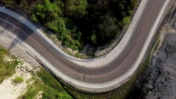 Top Down View of Winding Mountain Road with Cars