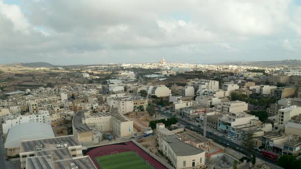 Fast Moving Hyperlapse Over Gozo Island, Malta with Church in Distance and Overcast Sky, Aerial