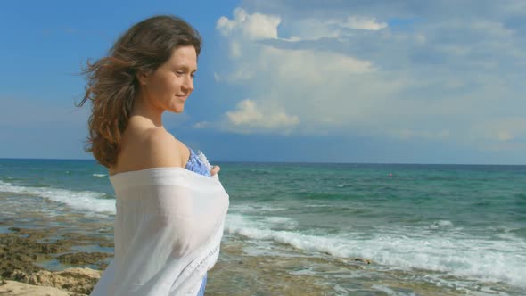 Flirty Mysterious Woman Standing Alone on Seashore, Enjoying Beautiful Sea View