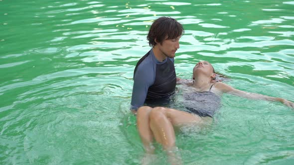 A Master of Watsu Massage Conducts a Massage in the Pool