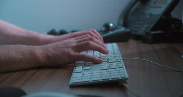 Typing keyboard man remote working, close-up slow motion, studio shot in 4K prores HQ