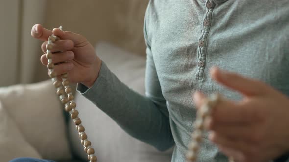 Beads on a Hand of a Man