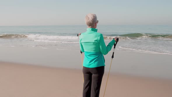 Senior Woman Exercising At The  Beach