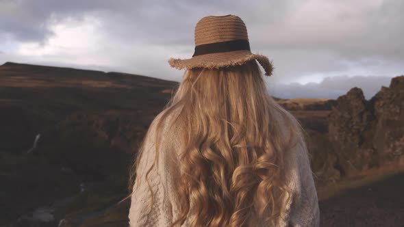 Blond Woman In Straw Hat In Icelandic Landscape