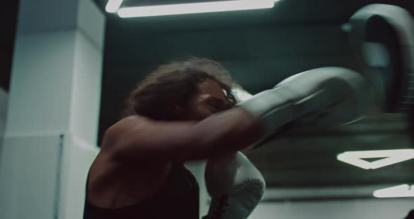 Black Man is Practicing Punches in Training Hall Striking Pads on Hands of Coach  Prores