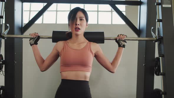 Asian young sport woman wear sportswear workout exercise with barbell at fitness or gym stadium club