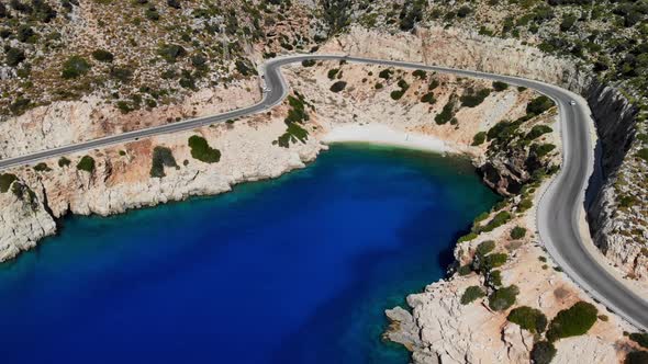 Top Aerial View of Beautiful Blue Bay Among Serpentine Mountain Road