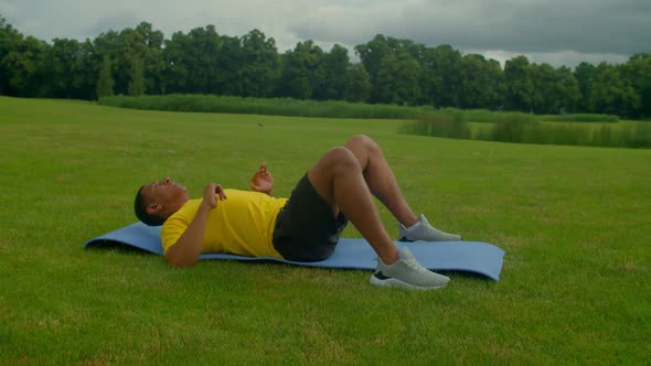 Athletic Motivated African American Man Doing Bodyweight Back Workout in Park