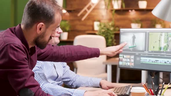 Two Male Colleagues Debating Over a New Video Project They Are Working on