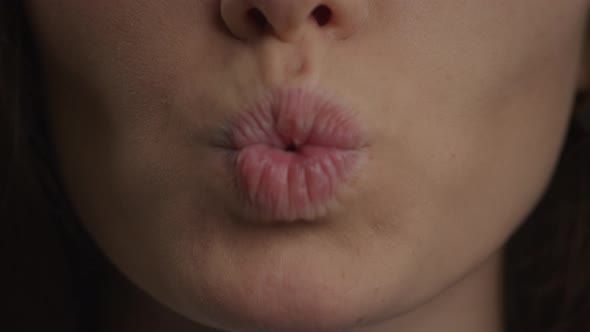 Close Up of a Caucasian Woman Lips Doing a Kiss and a Smile in Slow Motion