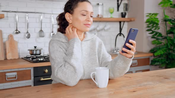 Brunette Sitting at the Table Using Mobile