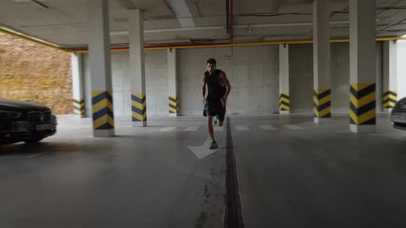 Young Man Runs Fast Inside the Parking Garage