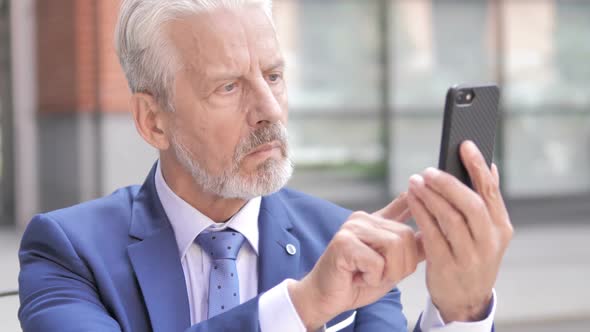 Old Businessman Using Smartphone Outdoor