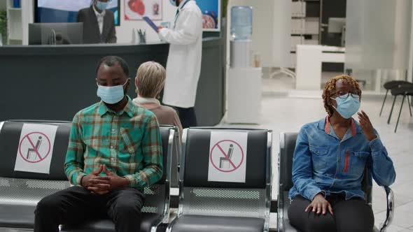 African American People Waiting in Hospital Reception to Attend Checkup Visit