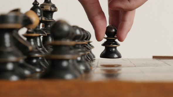 Black pawn moving in  chequered fields  strategic  game 4K 2160p 30fps UltraHD  footage - Wooden che alt