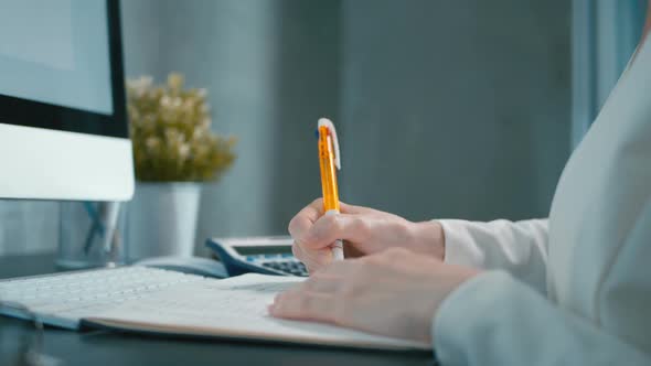 Financial Officer Writing In Office