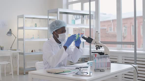 Male Scientist Analyzing Bacteria in Petri Dish