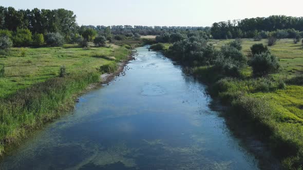 Aerial landscape of a lake surrounded by rural scene shot from a drone.