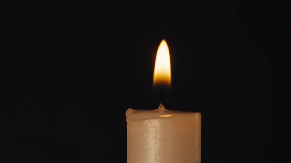 Burning Wax Candle on Black Chroma Key Background
