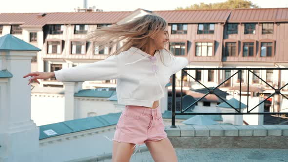 Beautiful smiling woman in summer hipster clothes. Dancing in the street