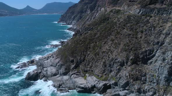 Drone flying above dramatically rugged coastline of Cape Peninsula - Chapman's Peak Drive, South Afr