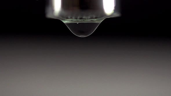 750474 Drop by Drop of Water falling from Tap against White background, Real Time